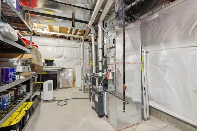 utility room featuring heating unit and gas water heater