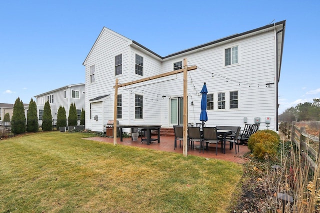 back of property with a patio area and a yard