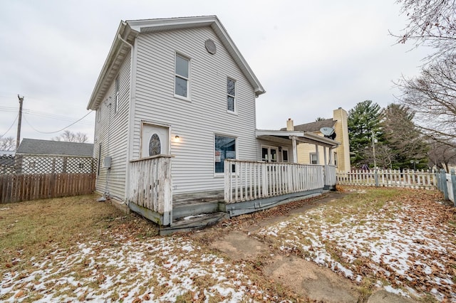 view of snow covered rear of property