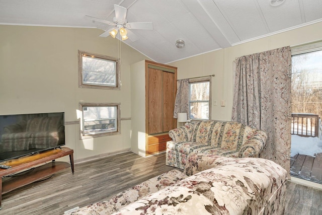 living room with vaulted ceiling, ceiling fan, hardwood / wood-style flooring, and ornamental molding