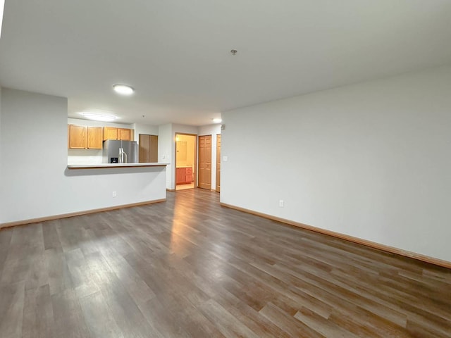 unfurnished living room featuring wood-type flooring