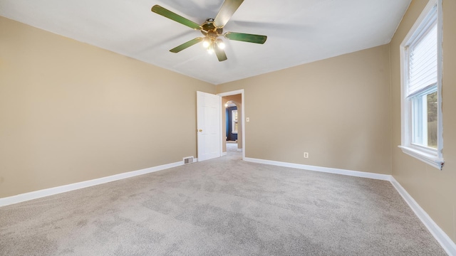 empty room featuring carpet and ceiling fan