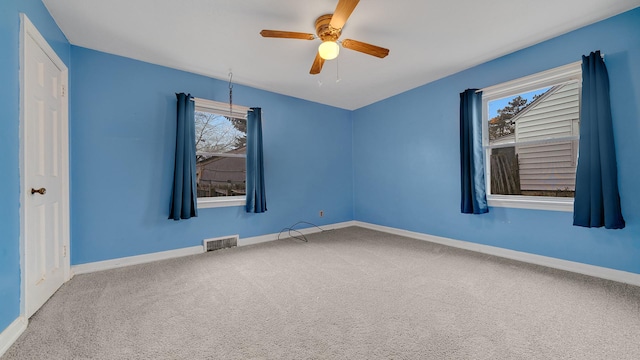 unfurnished room with carpet and ceiling fan