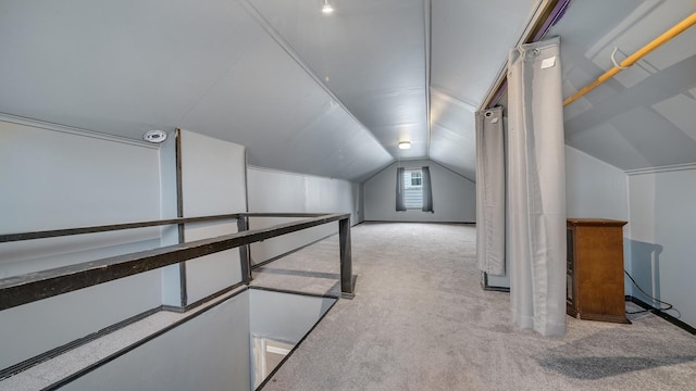 bonus room with light carpet and vaulted ceiling