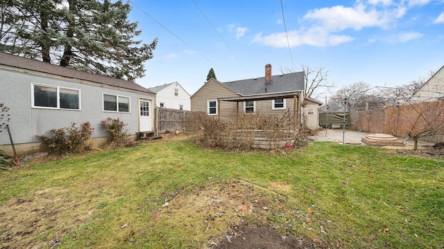 back of house featuring a yard and a patio