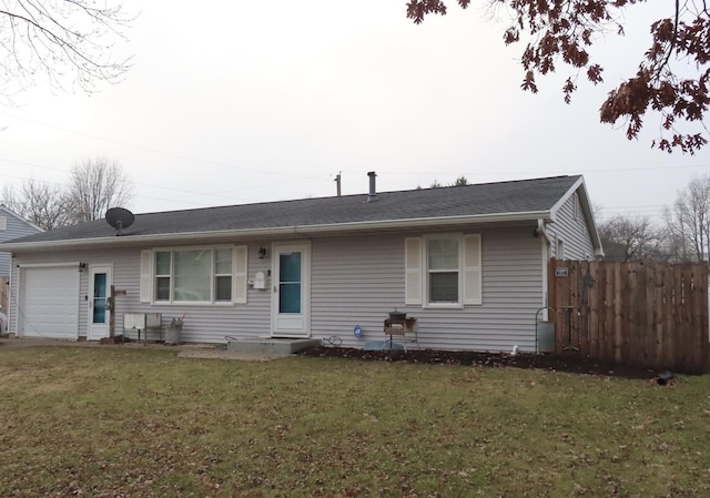 single story home featuring a garage and a front lawn