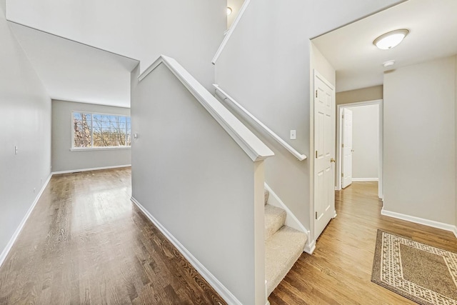 stairs featuring hardwood / wood-style floors