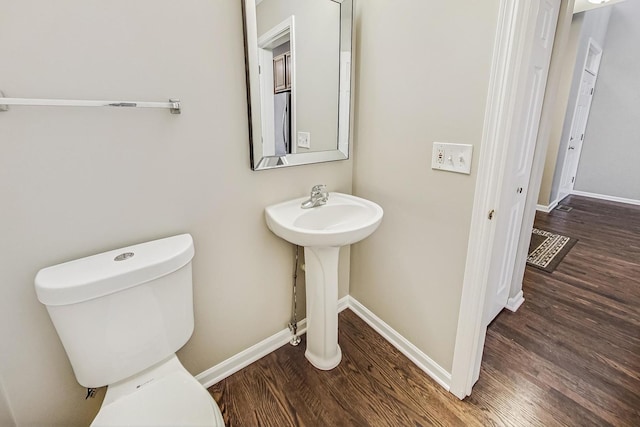 bathroom featuring hardwood / wood-style floors, toilet, and sink