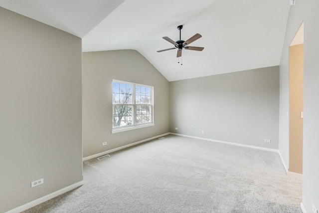 empty room with light carpet, vaulted ceiling, and ceiling fan