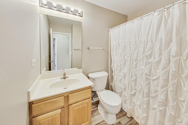 bathroom with wood-type flooring, vanity, a shower with shower curtain, and toilet