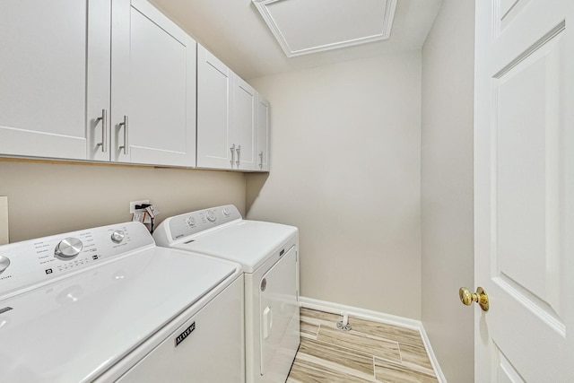 laundry area with cabinets and washing machine and clothes dryer