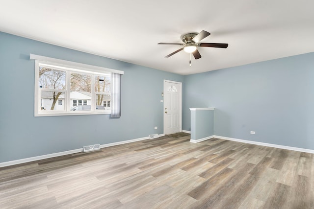 spare room with ceiling fan and light hardwood / wood-style flooring