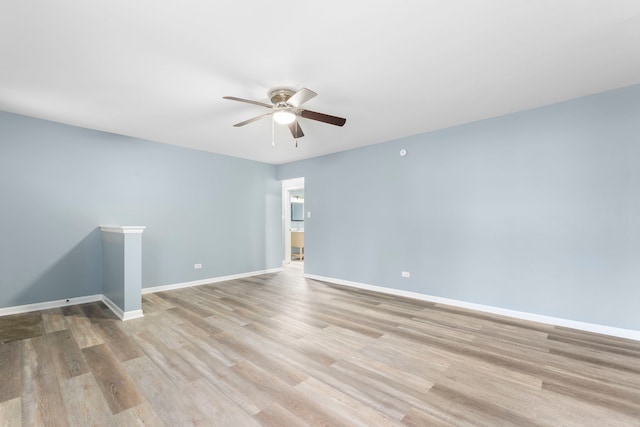 spare room with light hardwood / wood-style flooring and ceiling fan