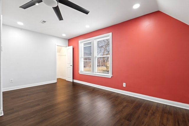 unfurnished room featuring ceiling fan, dark wood-type flooring, and vaulted ceiling