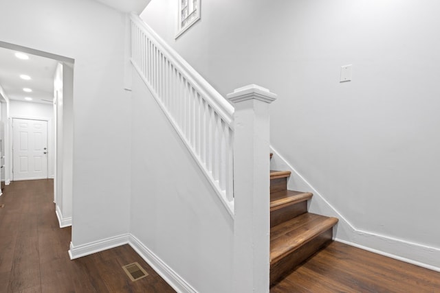 stairs featuring hardwood / wood-style flooring