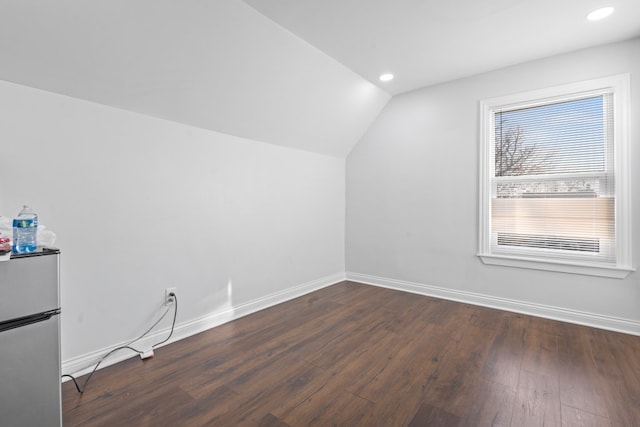 bonus room featuring dark hardwood / wood-style flooring and lofted ceiling