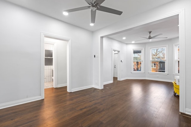 empty room with dark hardwood / wood-style flooring and ceiling fan