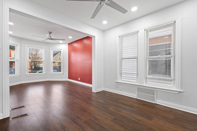 unfurnished room with dark hardwood / wood-style floors and ceiling fan