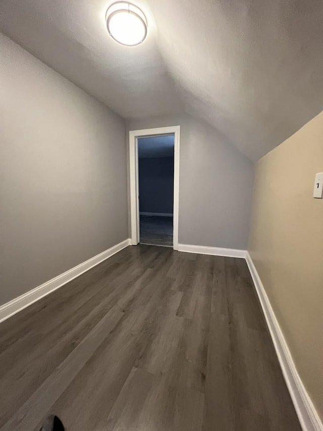 bonus room featuring dark hardwood / wood-style floors and lofted ceiling