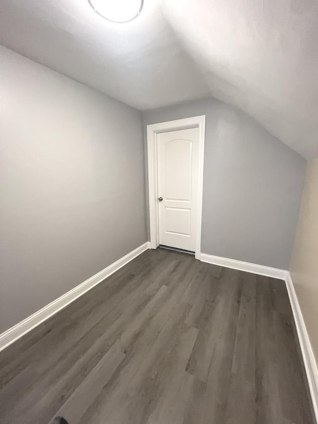 bonus room featuring dark hardwood / wood-style floors and lofted ceiling