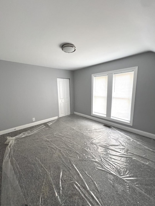 empty room with vaulted ceiling