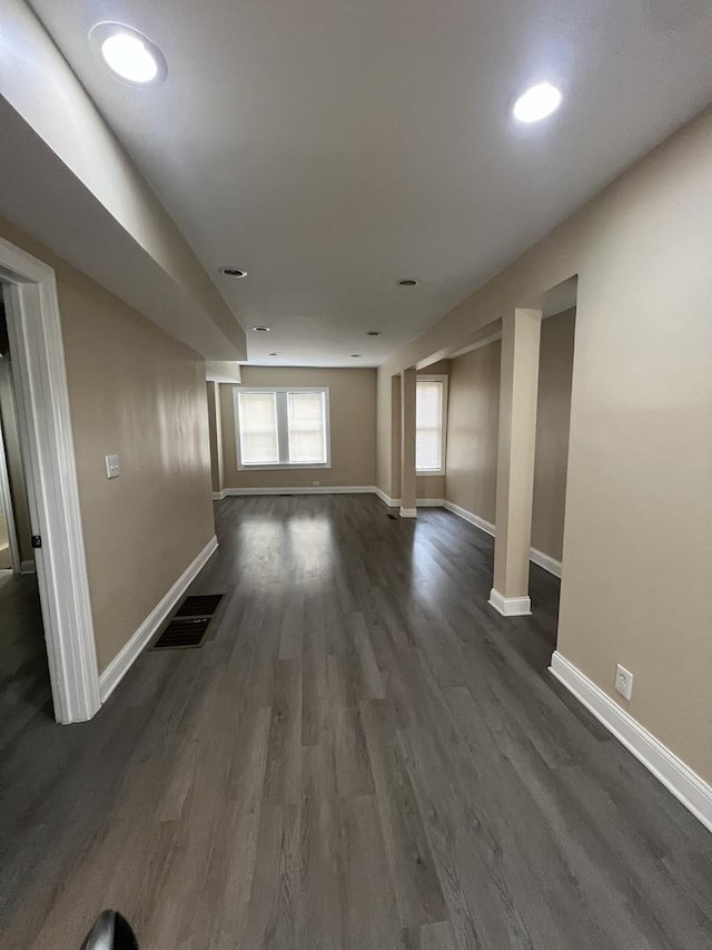 unfurnished living room with dark hardwood / wood-style flooring