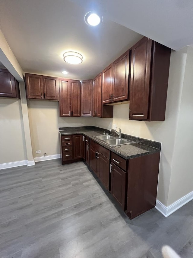 kitchen with light hardwood / wood-style flooring and sink