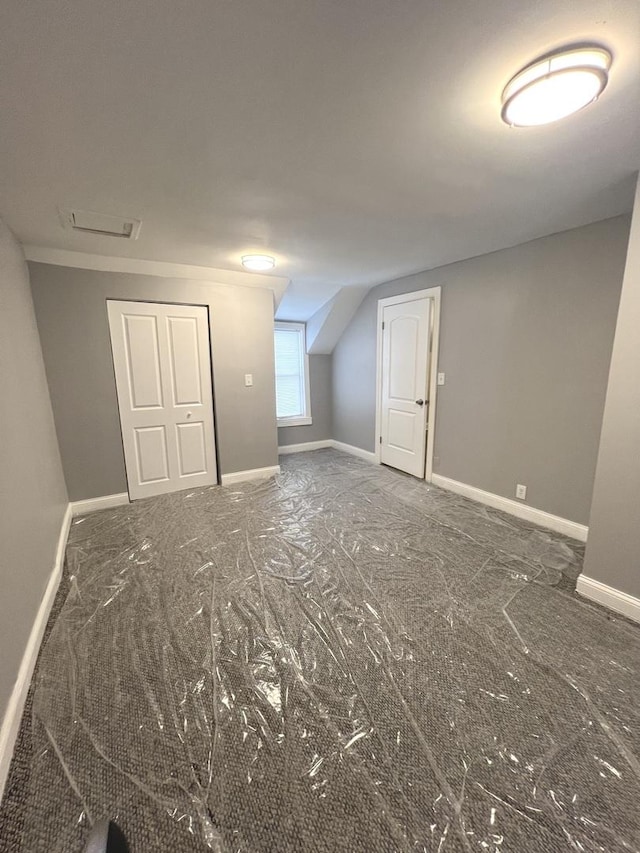 additional living space featuring lofted ceiling