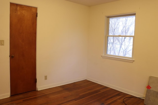 empty room featuring dark hardwood / wood-style flooring