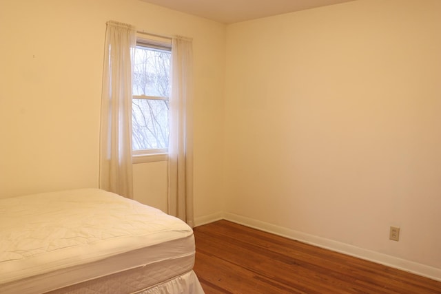 bedroom with hardwood / wood-style floors