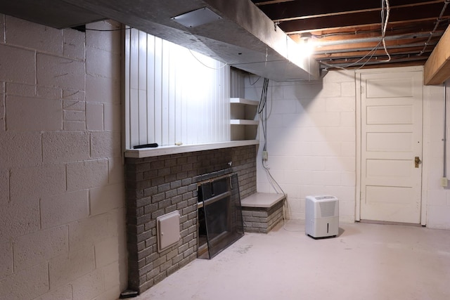 basement featuring a brick fireplace