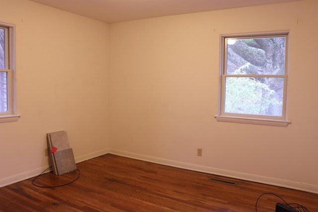 unfurnished room featuring dark wood-type flooring