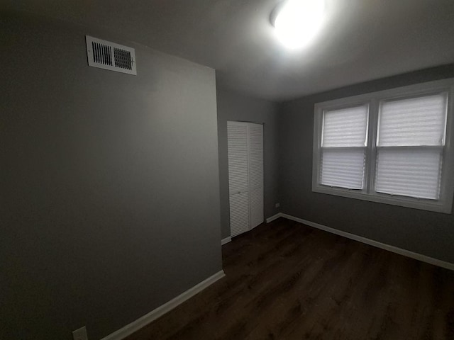 empty room featuring dark wood-type flooring