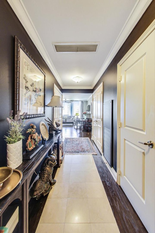 hall featuring tile patterned flooring and crown molding