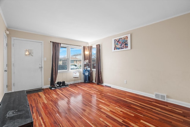 entryway featuring ornamental molding and hardwood / wood-style flooring