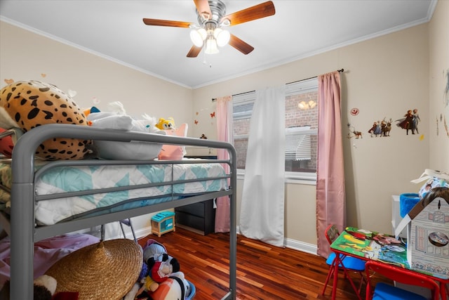 bedroom featuring dark hardwood / wood-style flooring, ceiling fan, and ornamental molding