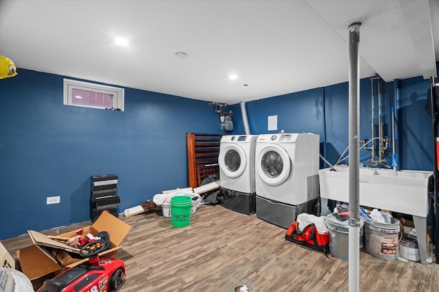 laundry area featuring wood-type flooring and washer and clothes dryer