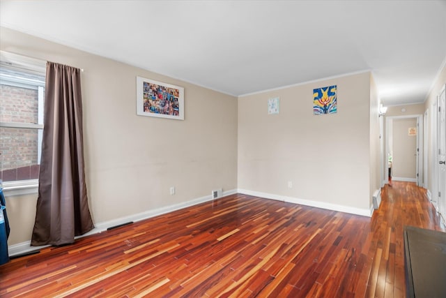 spare room with hardwood / wood-style flooring and ornamental molding