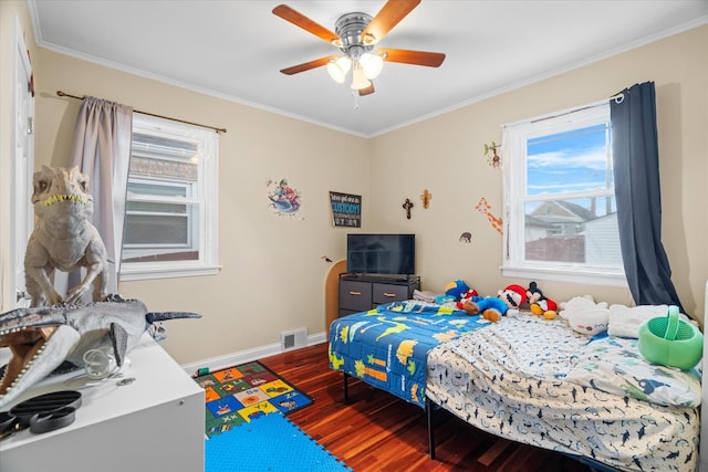 bedroom with ceiling fan, dark hardwood / wood-style flooring, and ornamental molding