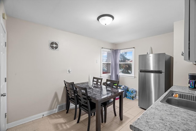 tiled dining area with sink