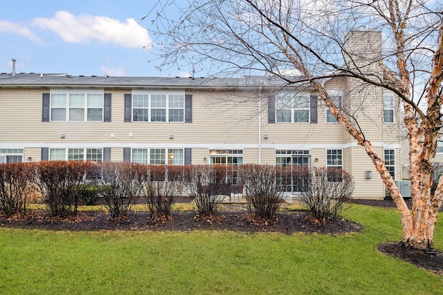 back of house featuring a lawn and central AC unit