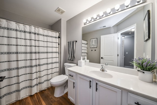 bathroom featuring vanity, wood-type flooring, and toilet