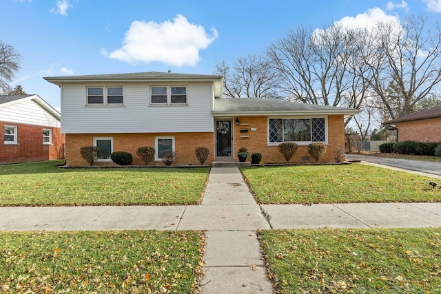 tri-level home with a front lawn