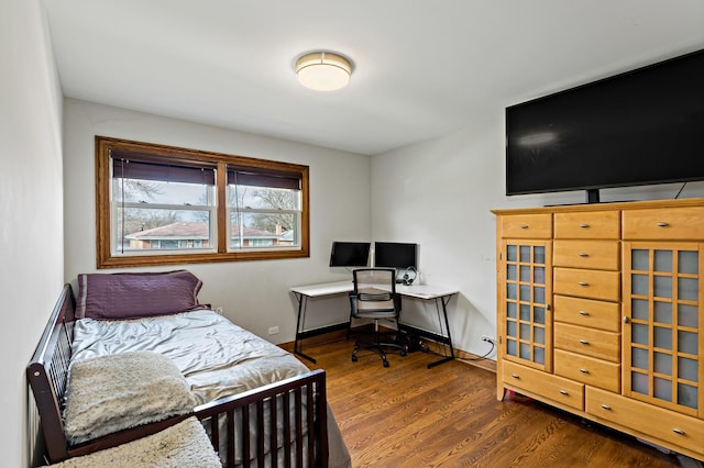 bedroom with dark wood-type flooring