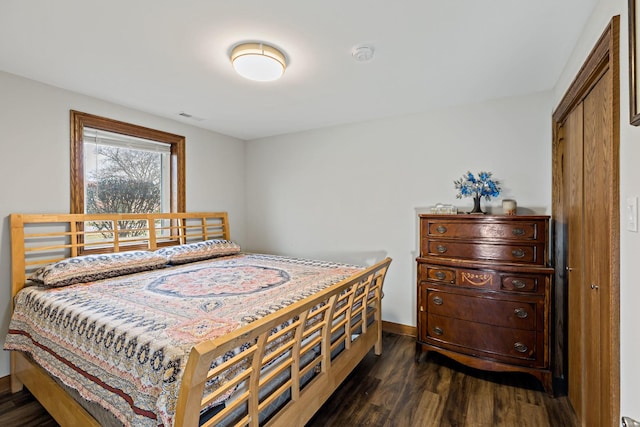 bedroom with dark wood-type flooring