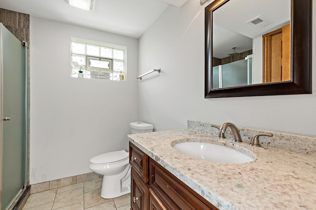 bathroom with tile patterned floors, vanity, toilet, and walk in shower