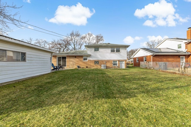 rear view of house featuring a yard