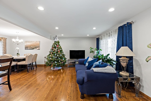 living room with wood-type flooring and a chandelier