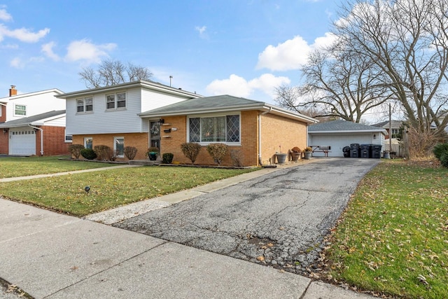 split level home featuring a garage and a front lawn