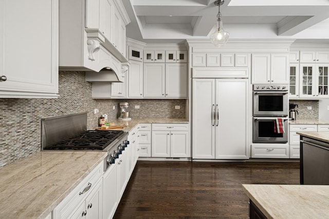 kitchen featuring white cabinets, pendant lighting, stainless steel appliances, and light stone countertops